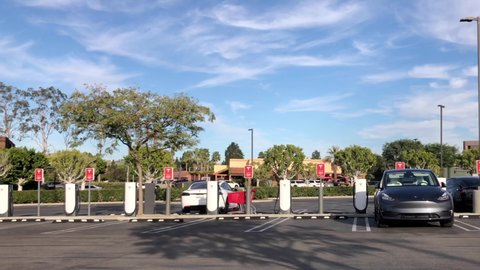 Anaheim, CA - Jan 26, 2022: 4K HD panning across Tesla supercharging station located in a Target parking lot.
