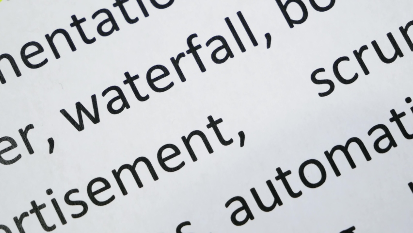 Word waterfall undelnines among other words printed on white paper. Waterfall development concept. Water fall SDLC system development life cycle methodology software, closeup