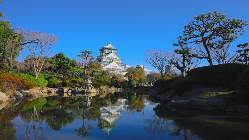 Osaka Castle Tower seen from the Japanese garden of Osaka Castle Park 4K UHD