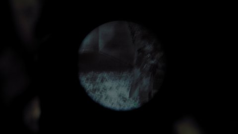 Sniper sits in ambush on an anti-terrorist operation in battle mode. Night vision sniper rifle scope. Special forces takeover of the building. Group of soldiers protecting front line