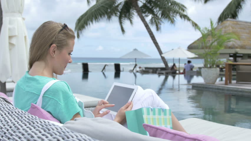 During vacation. Голова блондинка читающая книгу на пляже.