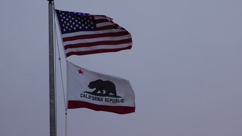 CALIFORNIA, USA - NOVEMBER  27, 2019: american flag and california flag fluttering in the wind, CA USA