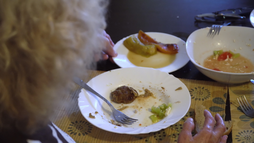 Grandmother eats meat at home