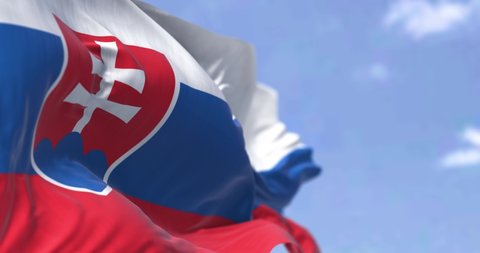 Detail of the national flag of Slovakia waving in the wind on a clear day. Democracy and politics. Central Europe country. Patriotism. Selective focus. Seamless Slow motion