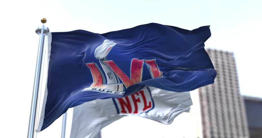 Inglewood, CA, USA, January 2022: The flag with the LVI Super Bowl logo waving in the wind with the NFL flag blurred in the background. The game is scheduled to take place on February 13, 2022 