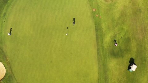 Golf playing, Players Play Golf Top also there's golf carts with golf clubs flag Shot view 4K Drone