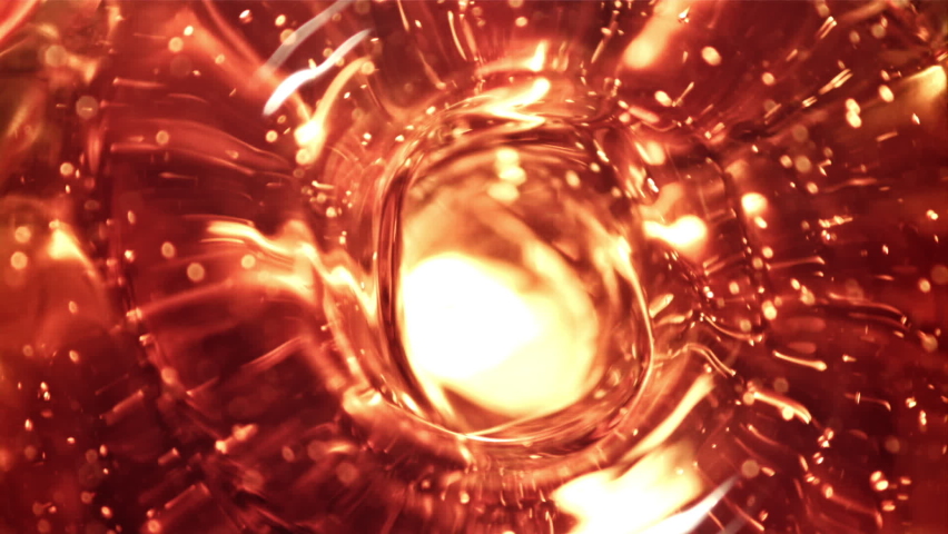 Whirlpool of whiskey. Macro background. Whiskey texture. Filmed on a high-speed camera at 1000 fps. High quality FullHD footage