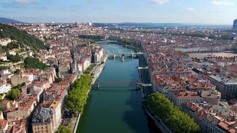 Lyon historical city center and Saône river banks with streets aerial drone video footage. Warm summer day with blue sky. Famous touristic holiday vacation destination in France and Europe.