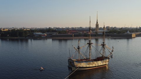 Aerial morning urban landscape with a replica of the ancient frigate Poltava against the background of the Peter and Paul Fortress before the holiday of the Russian Navy, water area of Neva river