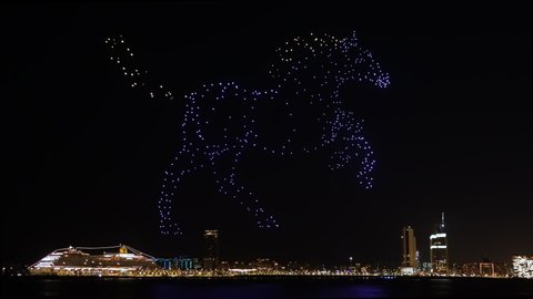 Dubai , United Arab Emirates - 01 11 2022: Drone light show displaying a horse figure on the night Dubai's sky 