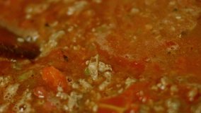 Mix all ingredients with a wooden spoon. Cook chili con carne, Mexican cuisine. Macro shooting