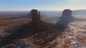 Drone point of view flying towards Monument valley rock formations in Navajo land in Utah USA. 4K aerial view of famous landmark in western USA. Wild West landscape from western movies with cowboys