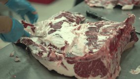 Close-up video Meat industry, butcher cut raw meat with a knife at table in the slaughterhouse, Wagyu Beef.
