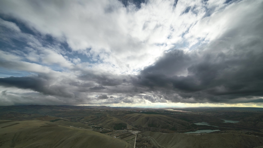 Variable mixed cloudy sky in continental climate.Different pieces of cumulus and nimbus clouds are moving in the sky.Cloud cluster in cloudscape.Overcast weather on terrestrial landscape.8K time lapse