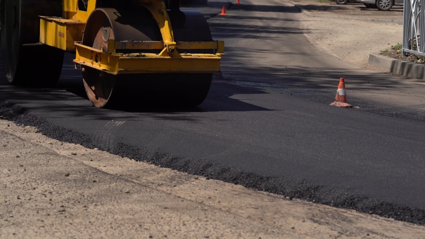 Road roller works on the construction of a new asphalt road. Road repair. Making new road Royalty-Free Stock Footage #1086275780