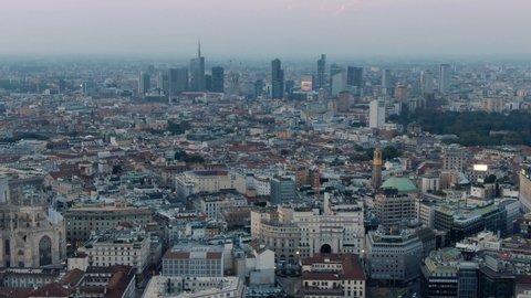 Aerial Drone Of Distant Milan Skyline and Milan Cathedral Duomo Di Milano At Sunset