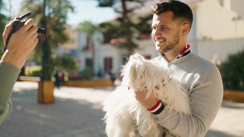 Young couple make picture using professional camera at park