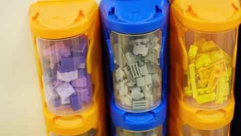 KREMENCHUG, UKRAINE - FEBRUARY 17, 2020: multicolored Lego containers full of Lego bricks in a playroom.