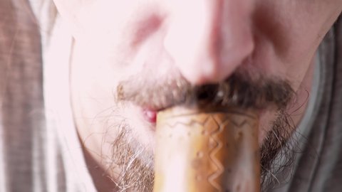 one of a series of smoking medical cannabis. bearded caucasian man lighting a bong smoking pipe. close up