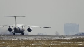 Slow motion video of a plane taking off from the runway in winter in bad weather.