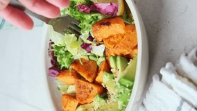 Baked sweet potato slices with avocado and green salad. Healthy vegan food concept. - Powered by Shutterstock - Get 15% off with code: PIKWIZARD15