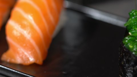 sake sushi, unagi sushi on a serving plate. sushi on a dark background. Japanese food