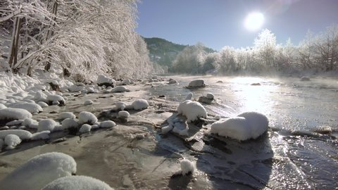 Peace and quiet in the winter nature. Mountain river on a sunny morning.