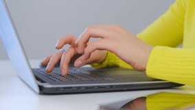 Freelancer woman typing text on notebook computer in closeup 4k video. Freelance writer person doing distant work on modern laptop. Female working from home during lockdown