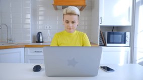 Beautiful young woman working at home on lockdown. White female doing distant work on laptop computer connected to internet. Professional freelancer person studying online with modern notebook pc