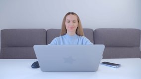 Young business woman typing on laptop computer at home. Focused freelancer female doing distant work online during lockdown. Entrepreneur person working on notebook pc in 4k stock video