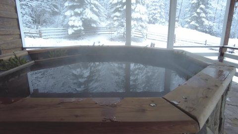 Hot bath and thermal spa at winter holidays in the mountains