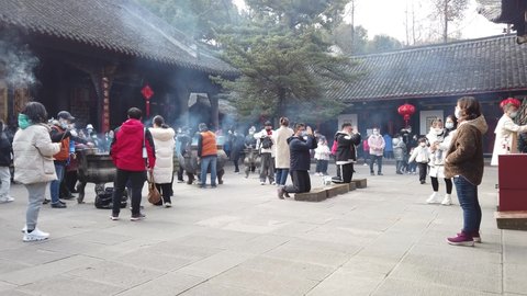 Chengdu, Sichuan province, China -Jan 29, 2022 : People praying and burning incense sticks in Wenshu buddhist monastery before the Chinese new year.