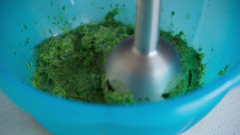 Preparation of spinach with a mixer, cooking. Selective focus