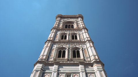 Tilt down of marble facade of Giotto bell tower, Cathedral of Saint Mary of the Flower, Florence, Italy
