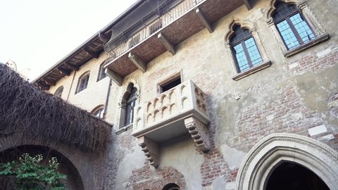 VERONA, ITALY - 10 Nowember 2021: People visiting the bronze statue of Juliet and Juliets balcony in Verona