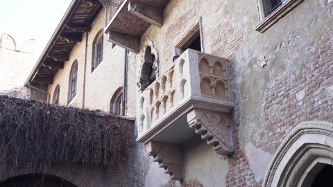 VERONA, ITALY - 10 Nowember 2021: People visiting the bronze statue of Juliet and Juliets balcony in Verona