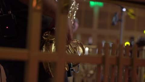 PETERSBURG, RUSSIA - DECEMBER, 17, 2021: Saxophonist playing saxophone at the party. Man with golden sax player. Wind musical instrument at the party or concert indoors. 