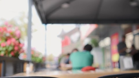 Image blur or client defocusing in a outdoor cafe.