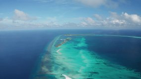 Scenic aerial flight over an idyllic white sand beach and tropical island. Fulhadhoo, Maldives