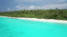 Scenic aerial flight over an idyllic white sand beach and tropical island. Fulhadhoo, Maldives