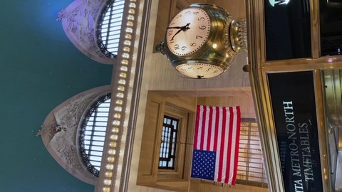 NEW YORK, USA - MAY, 18, 2021: Public clock in a hall lobby of Grand Central terminal railway station indoors. Board with information and train timetable, MTA ticket office.