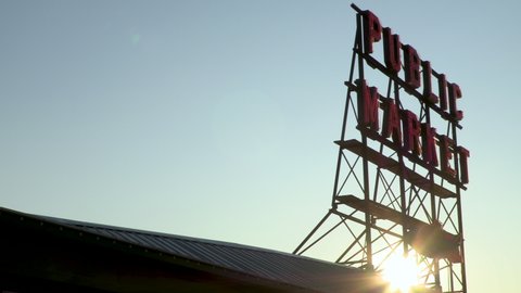 PIKE PLACE MARKET AT SUNSET, SEATTLE, WASHINGTON, USA – 29 JULY 2019 Sun setting behind Pike Place Public Market Sign, Seattle, Washington, USA