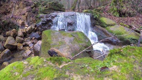 Weilerbach, South Eifel, German-Luxembourg Nature Park, Rheinland-Pfalz, Germany: A gentle creek cascades over an old small dam in winter
