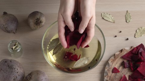 Preparation of beet kvass - putting peeled and sliced beetroot into brine with spices
