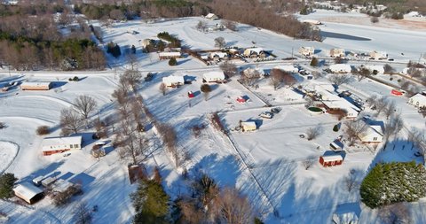 Aerial view a suburb after a fresh snow fall is shining brightly all roofs ground is covered in clean white snow