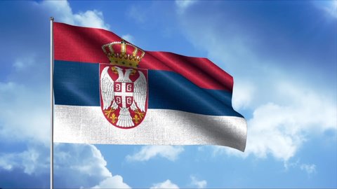 Flag of Serbia. Motion.The wind blows the flag in the blue sky with clouds.