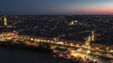 Nightlife starts, Establishing Aerial View Shot of Bordeaux Fr, world capital of wine, Nouvelle-Aquitaine, France at night evening