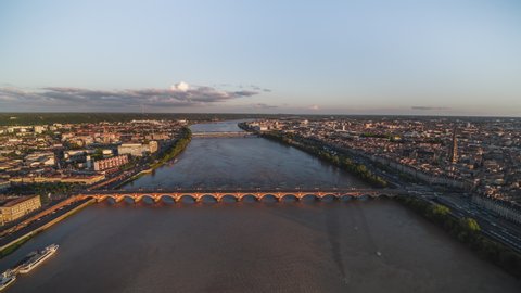 Sunset, Stone Bridge, Track Back, Establishing Aerial View Shot of Bordeaux Fr, world capital of wine, Nouvelle-Aquitaine, France