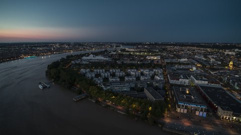 Bordeaux, France - circa 2021 - Late sunset, City falls asleep, Establishing Aerial View Shot of Bordeaux Fr, world capital of wine, Nouvelle-Aquitaine, France at night evening