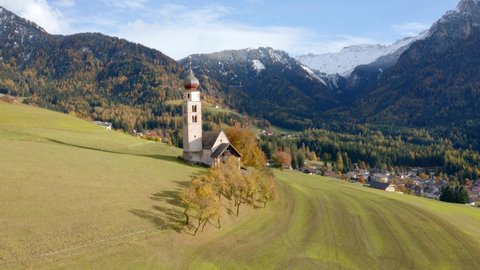 4k drone forward video (Ultra High Definition) of St. Valentin ( Kastelruth ) church. Picturesque autumn scene of Kastelruth village, Province of Bolzano - South Tyrol, Italy.